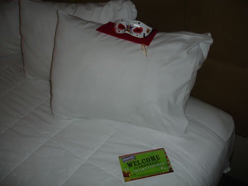 mardi gras mask on pillow at check-in
