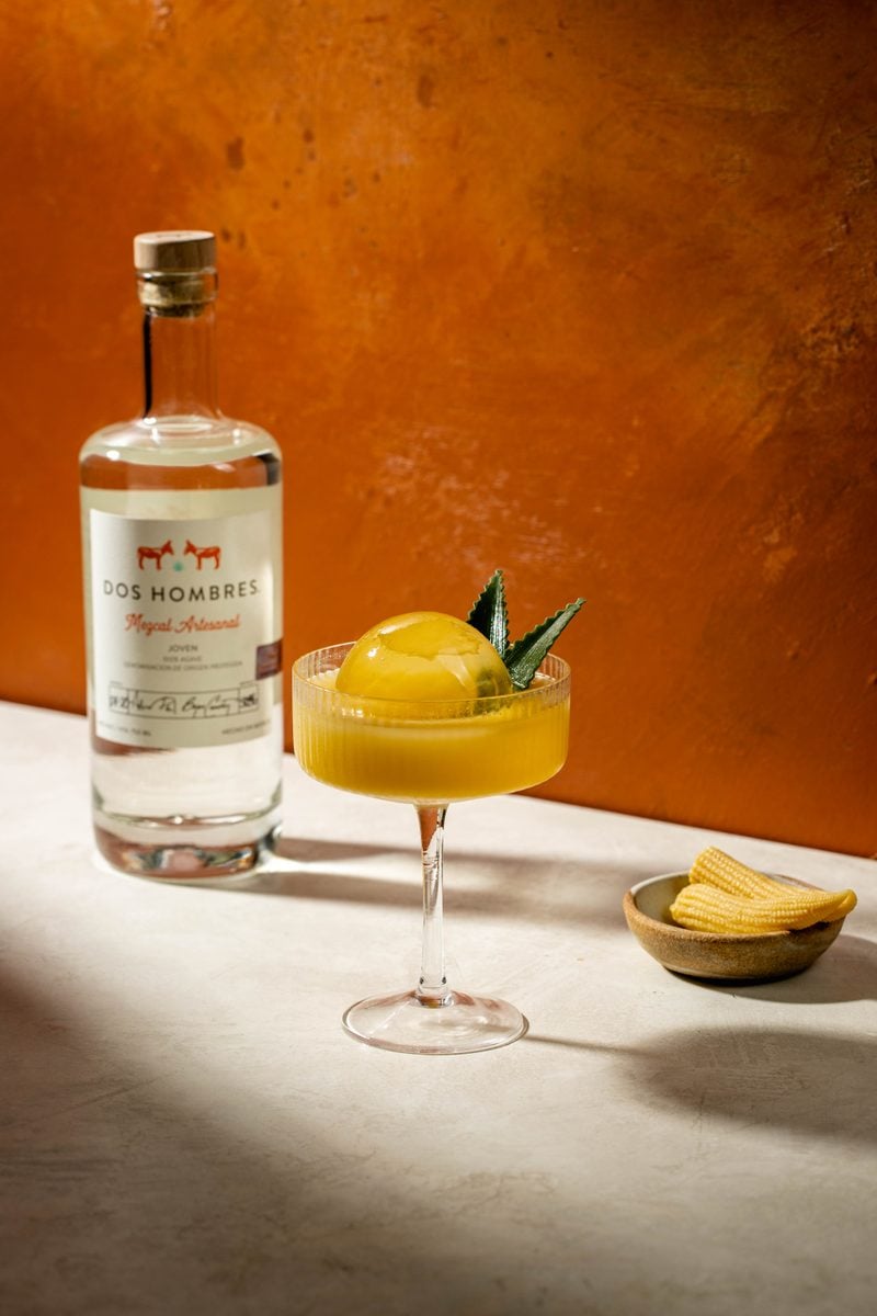 La Otra Palabra Dos Hombres mezcal cocktail with corn and agave garnish