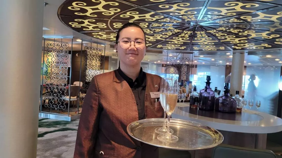 champagne host welcoming you to Celebrity Cruise