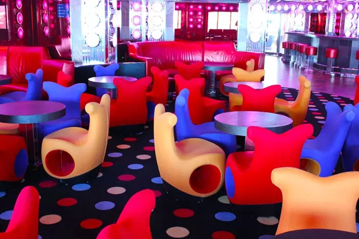 brightly colored chairs in discotec