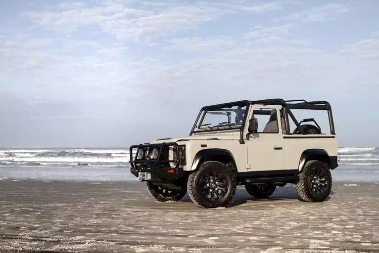 custom land rover defender project ranger in surf at beach