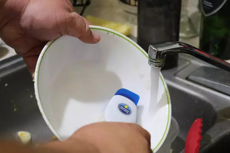 rinse and scrub dishes before placing in washer