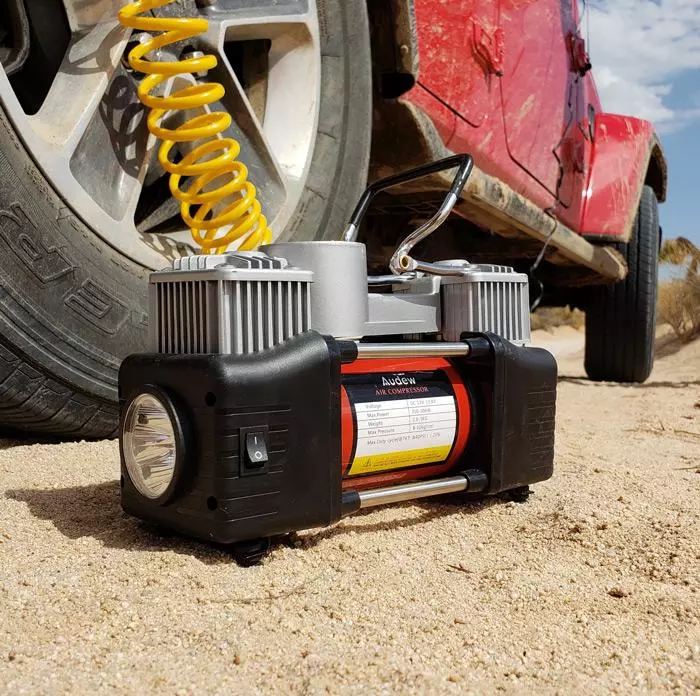 audew air compressor airing down on sand trail