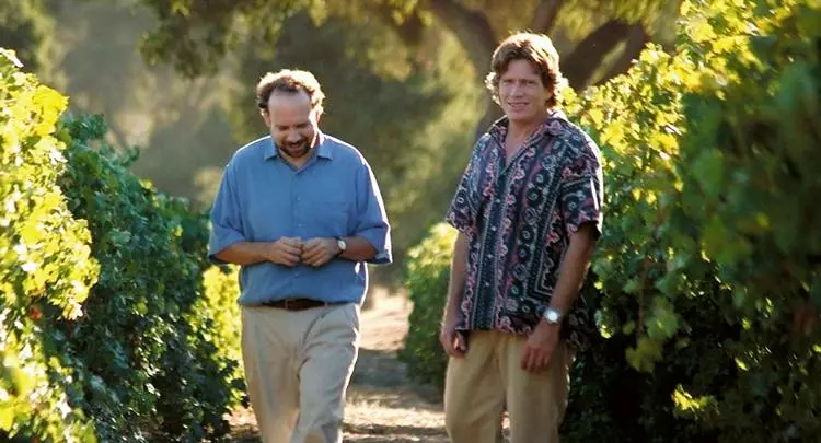 miles and jack walking through a vinyard