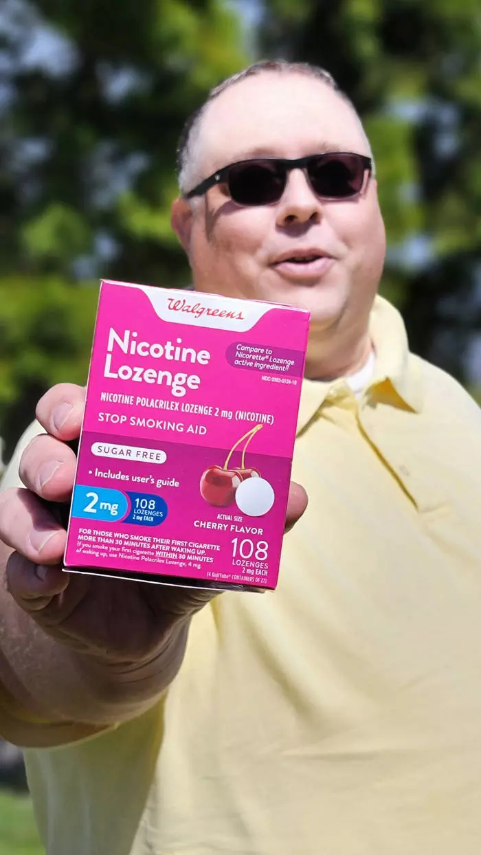 james standing tall holding lozange box
