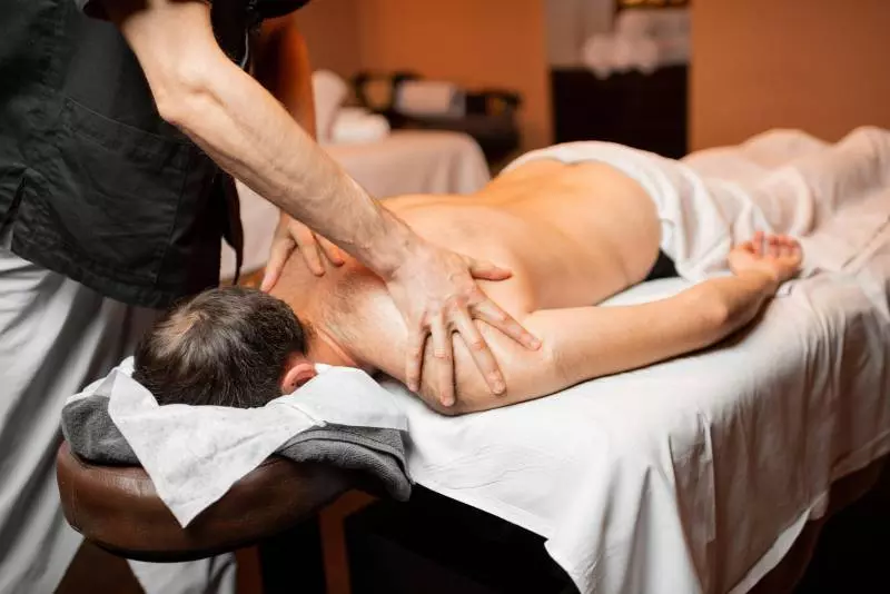 man getting a massage by a therapist