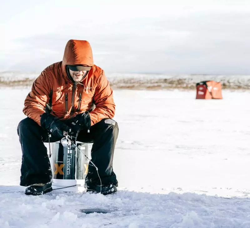 ice fishing on frozen canadian lake