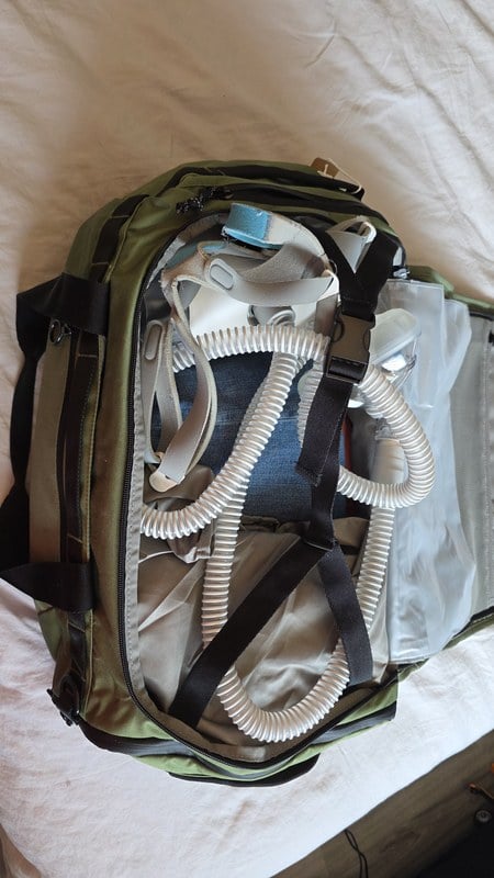 BagSmart Paz 43L duffle backpack packed with a BiPAP machine, mask, and hose