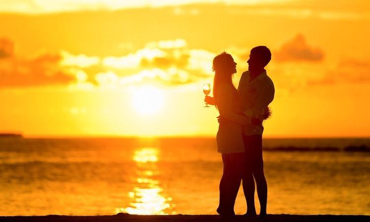 Couple embraces at sunset, symbolizing tips for better boyfriend qualities.