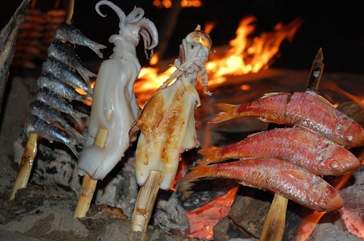 skewers of fish on marbella beach spain