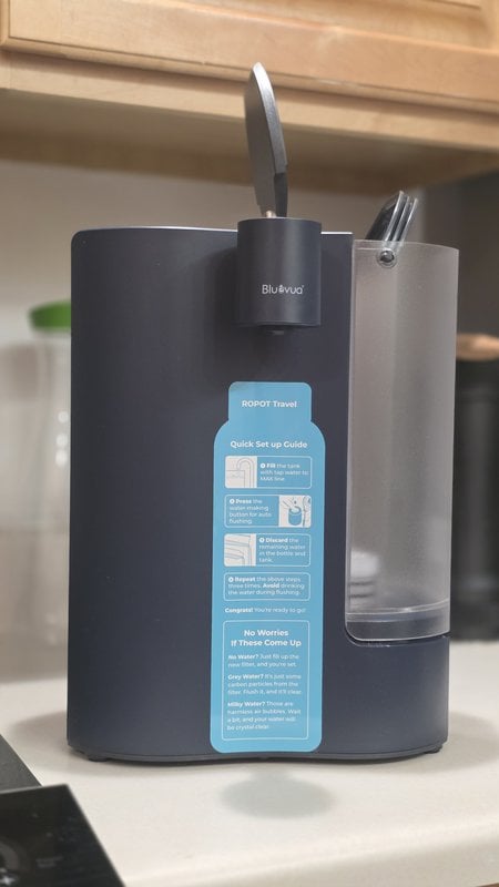 Bluevua ROPOT-Travel on a kitchen counter with the quick setup guide sticker on the front panel