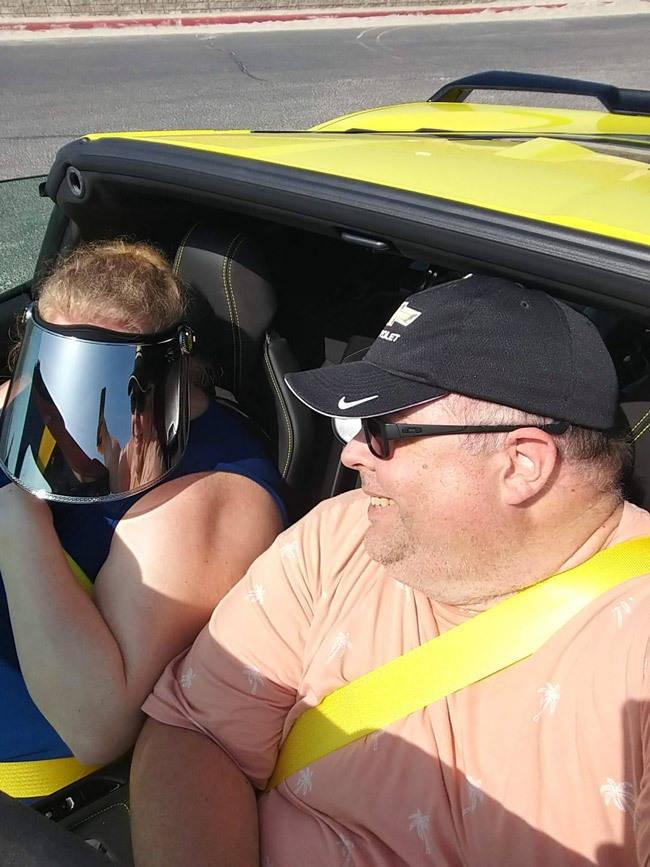 two big people in the corvette