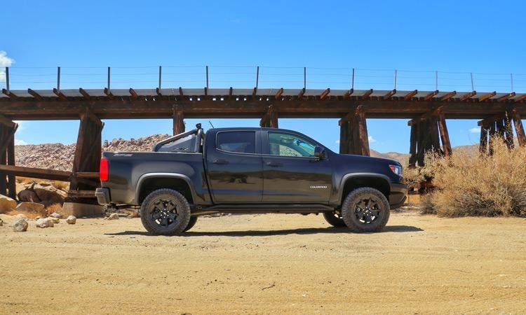 chevy zr2 midnight edition by railroad bridge