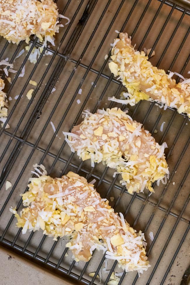 crispy coconut chicken tenders on baking rack ready to cook