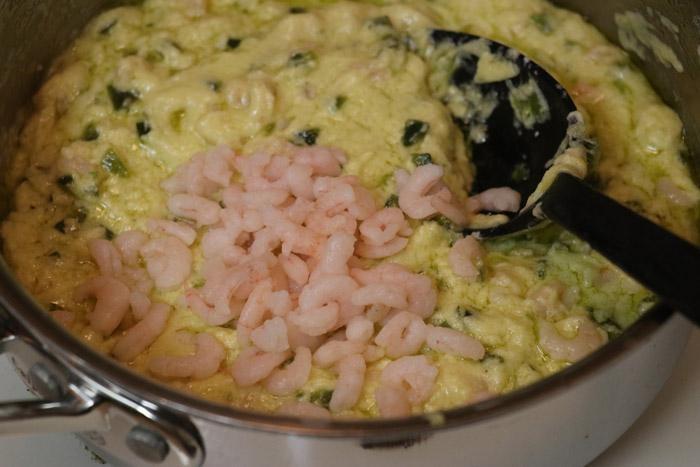 mixing shrimp into sauce