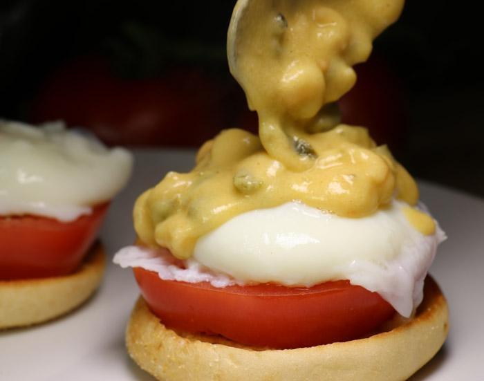 pouring poblano shrimp sauce over eggs benedict