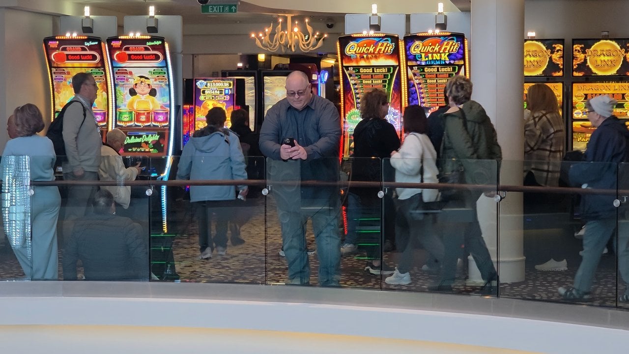 James checking his phone outside the casino on Norwegian Getaway