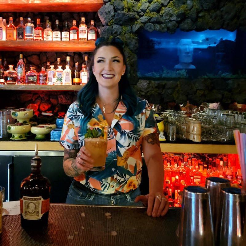 bartender at the grass skirt serving mai tai