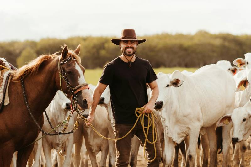 man on dude ranch playing cowboy