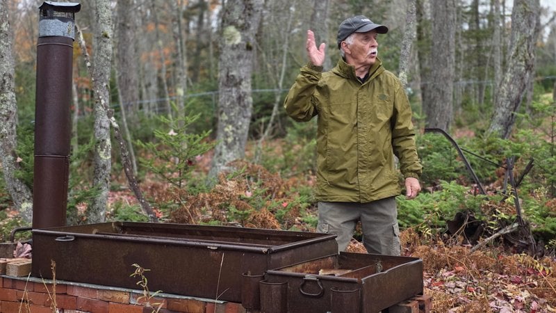 Gig Keirstead explaining an antique wood-fired maple evaporator pan in the maple woods at Elmhurst Outdoors