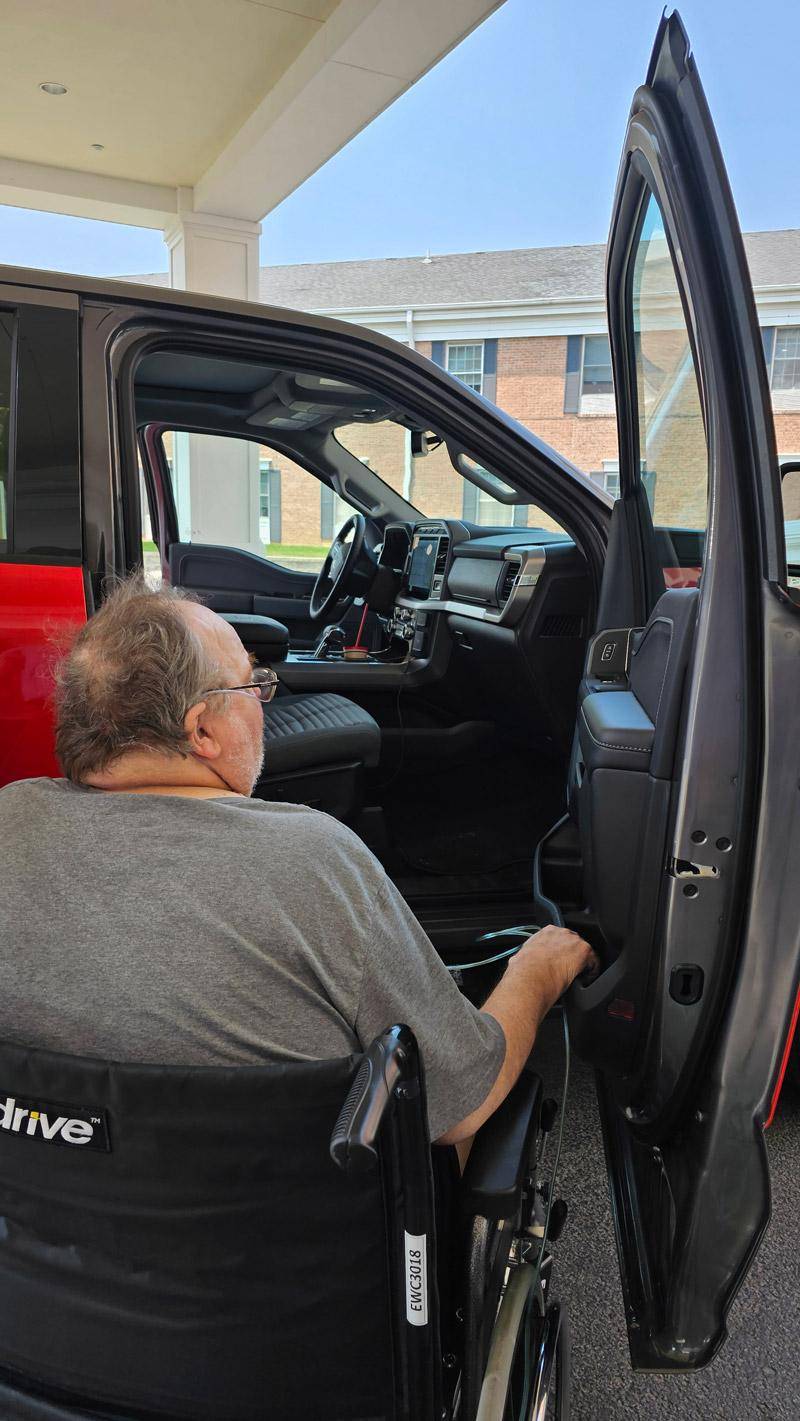 jim looking at truck interior