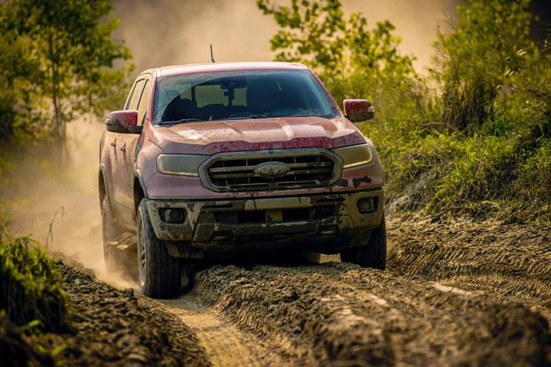ford ranger tremor driving through muddy offroad trail
