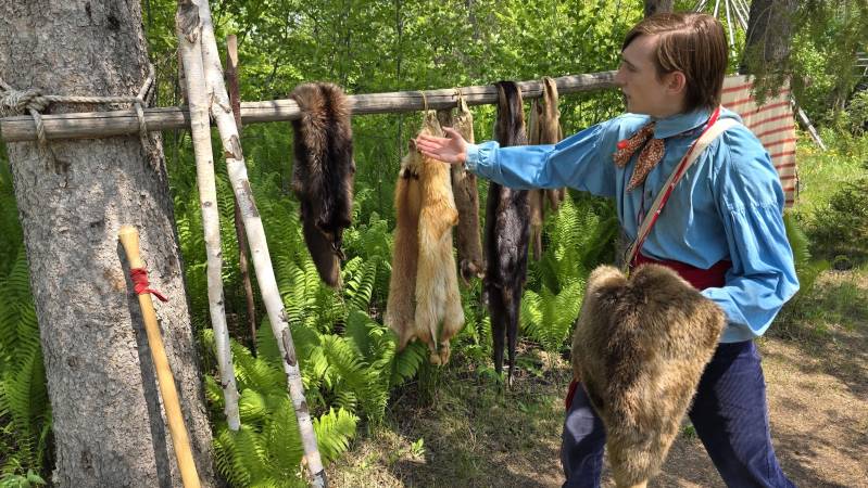 voyageuer showing off furs