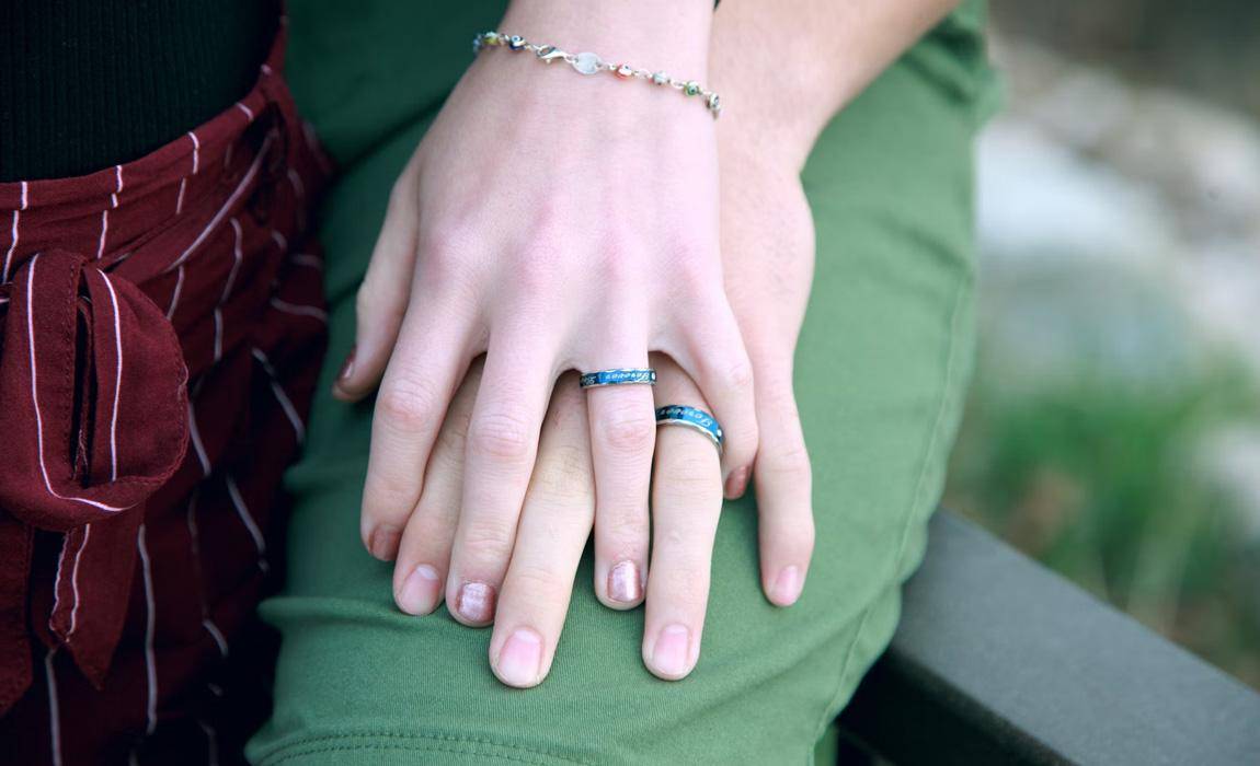 a couple with matching engagement rings