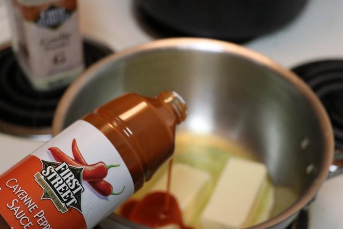 pouring first street cayenne pepper sauce