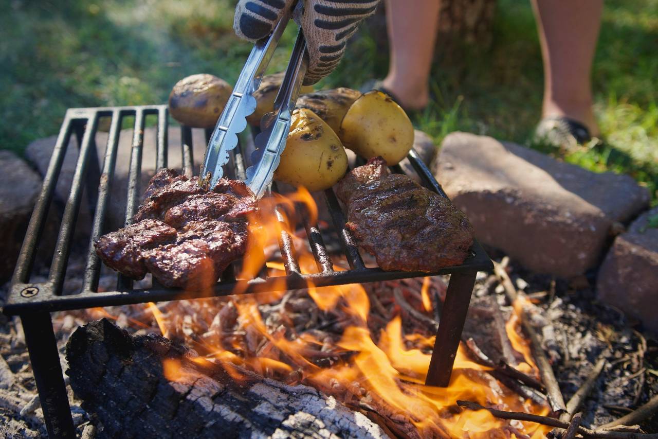 grilling steaks and potatoes