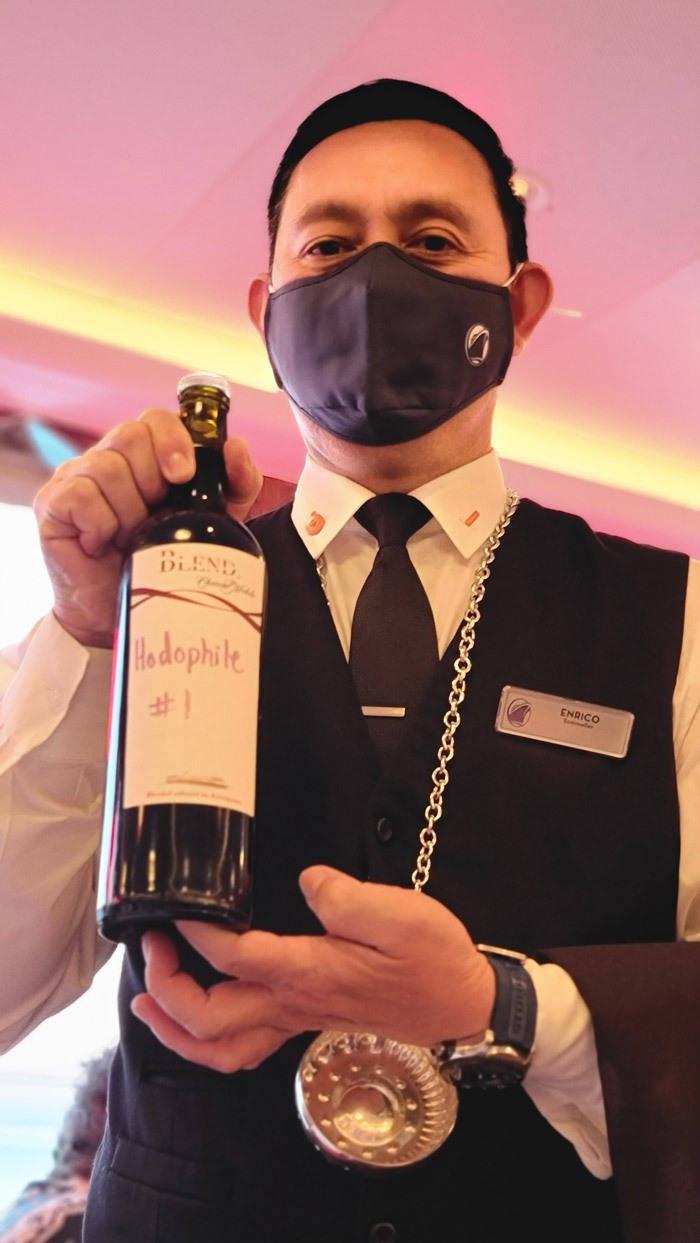 somm enrico presenting wine from blend