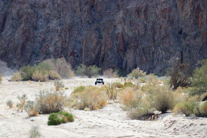 baja challenge car in desert sand wash