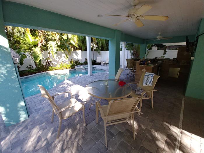 outdoor kitchen and pool area beachy villa vista vacation rental anna maria island florida