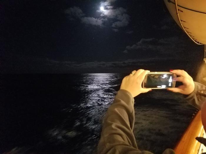 white blur moon photograph from cruise ship