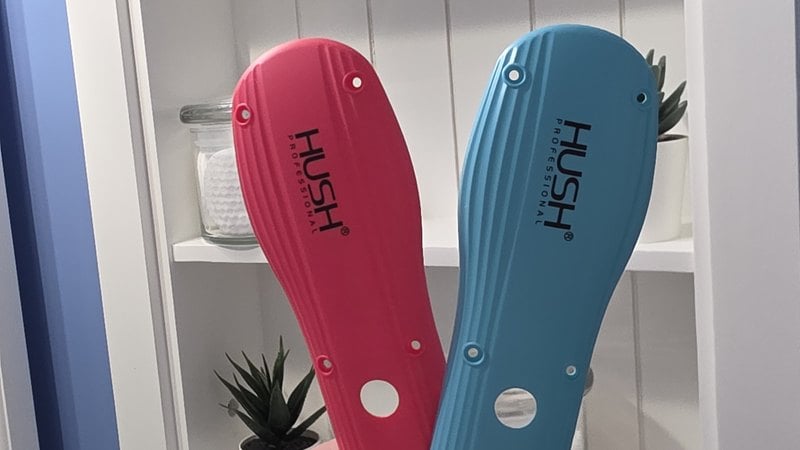 The blue and pink HUSH Pro Clipper body kits held up side by side
