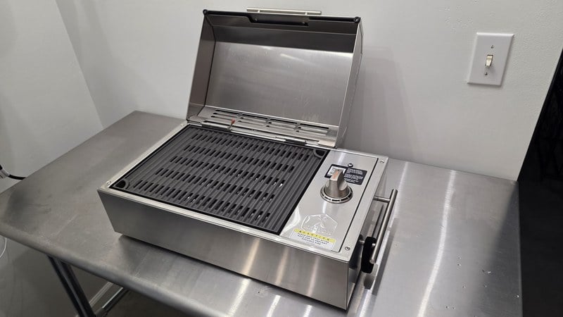 The Kenyon City Grill on a stainless counter with its faceted lid open