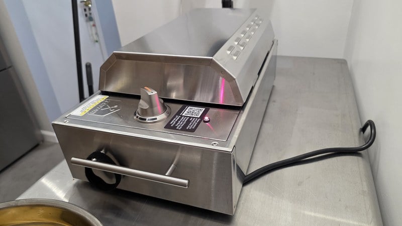 Side profile of the Kenyon City Grill showing the control knob and power cord