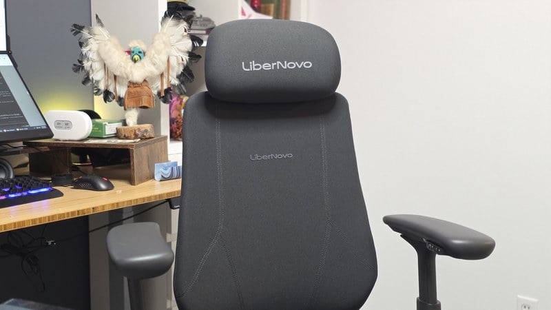 The LiberNovo Maxis chair at James's desk with a monitor, keyboard and mouse visible on the desktop