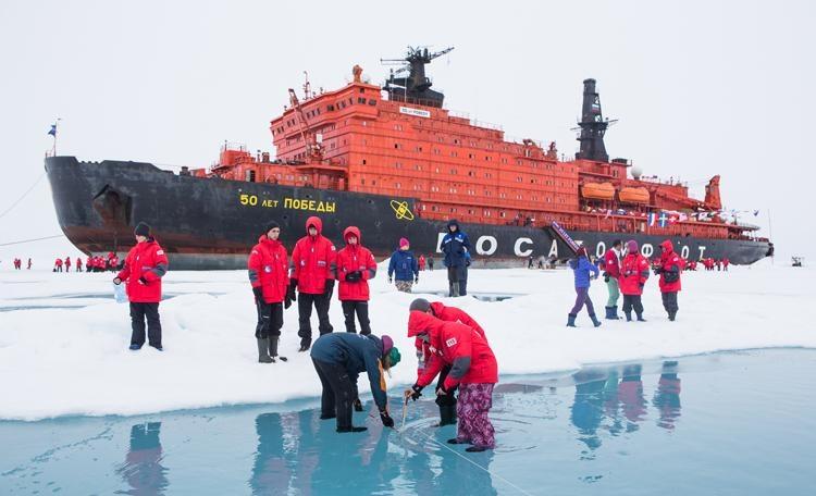 examining the ice on a north pole cruise