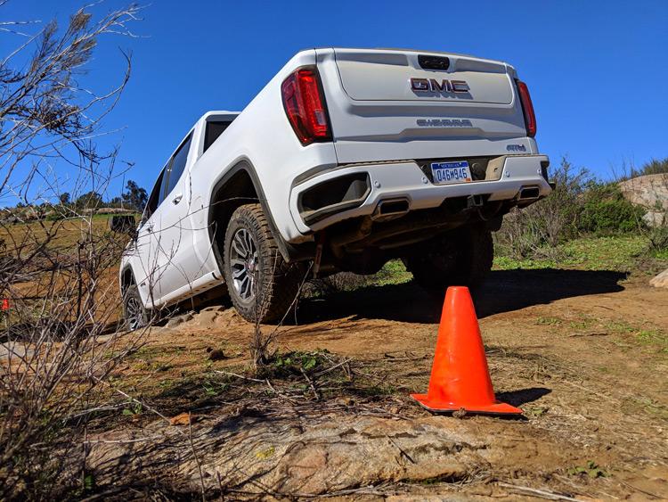 rear of gmc sierra at4 on off road course