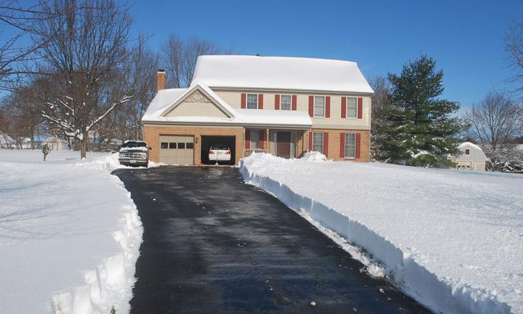 residential driveway with snow