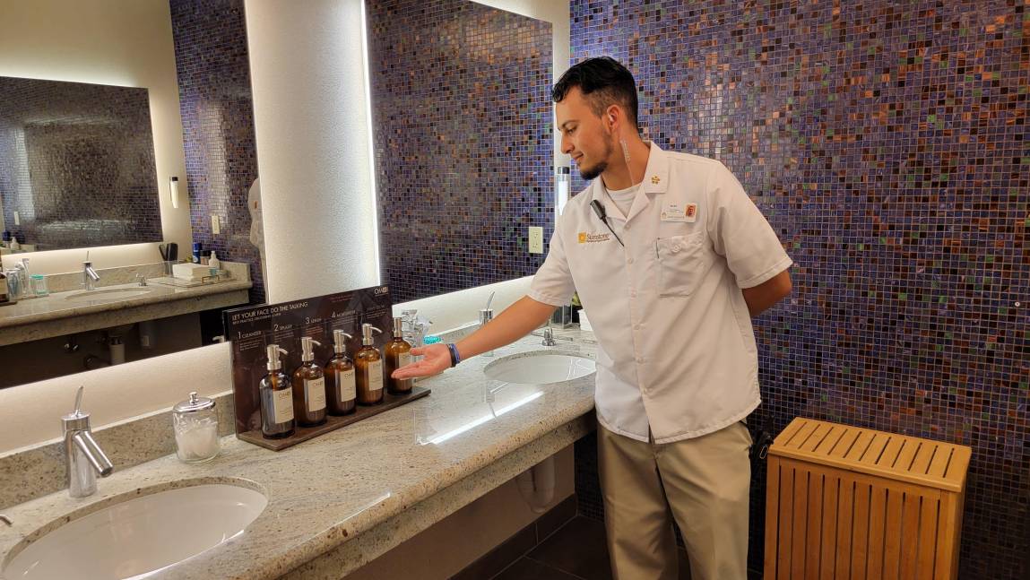 male attendant at spa helping make a group of guys feel comfortable on a guys spa weekend getaway