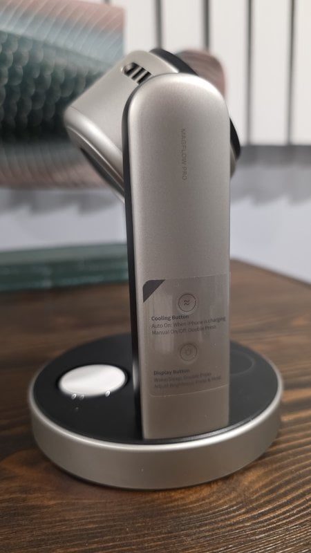 The arm of the UGREEN MagFlow Pro with its label explaining the cooling button and display button, the Apple Watch puck in the base