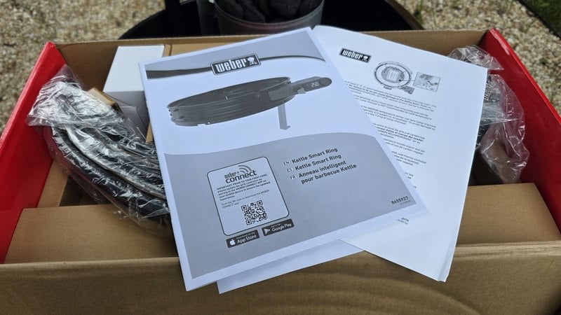 Weber Kettle Smart Ring box opened with the quick start guide, the Weber Connect app code and the packed components