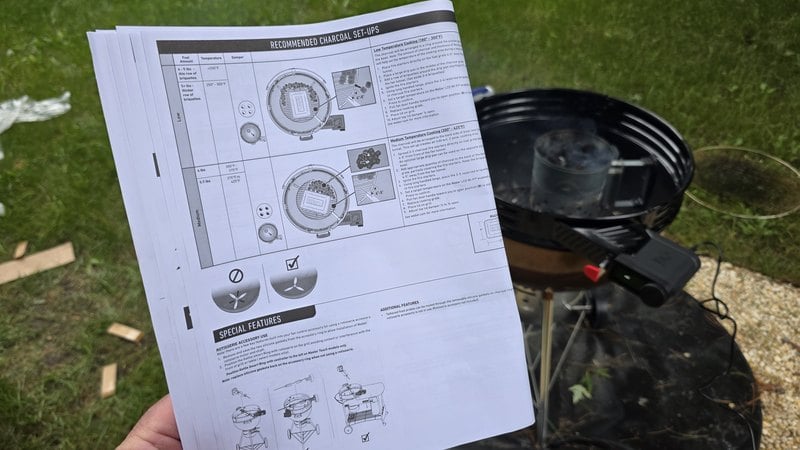Weber Kettle Smart Ring manual open to the recommended charcoal set-ups page with the kettle waiting in the background