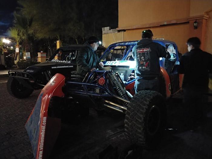 wide open baja pit crew rebuilding transmission in parking lot of hotel