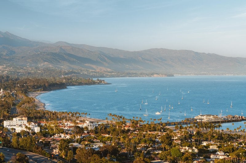 Aerial view of the Santa Barbara coastline and harbor below the Santa Ynez Mountains (photo credit: Blake Bronstad, Visit Santa Barbara)