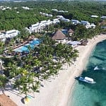 Aerial view of a palm-lined beach and pools at an all-inclusive resort on Mexico's Riviera Maya
