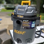 The Vacmaster Beast Series FLT+ 10-gallon wet dry vac set up outside on a work table