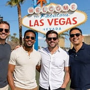 Four friends standing in front of the Welcome to Fabulous Las Vegas sign on a guys trip
